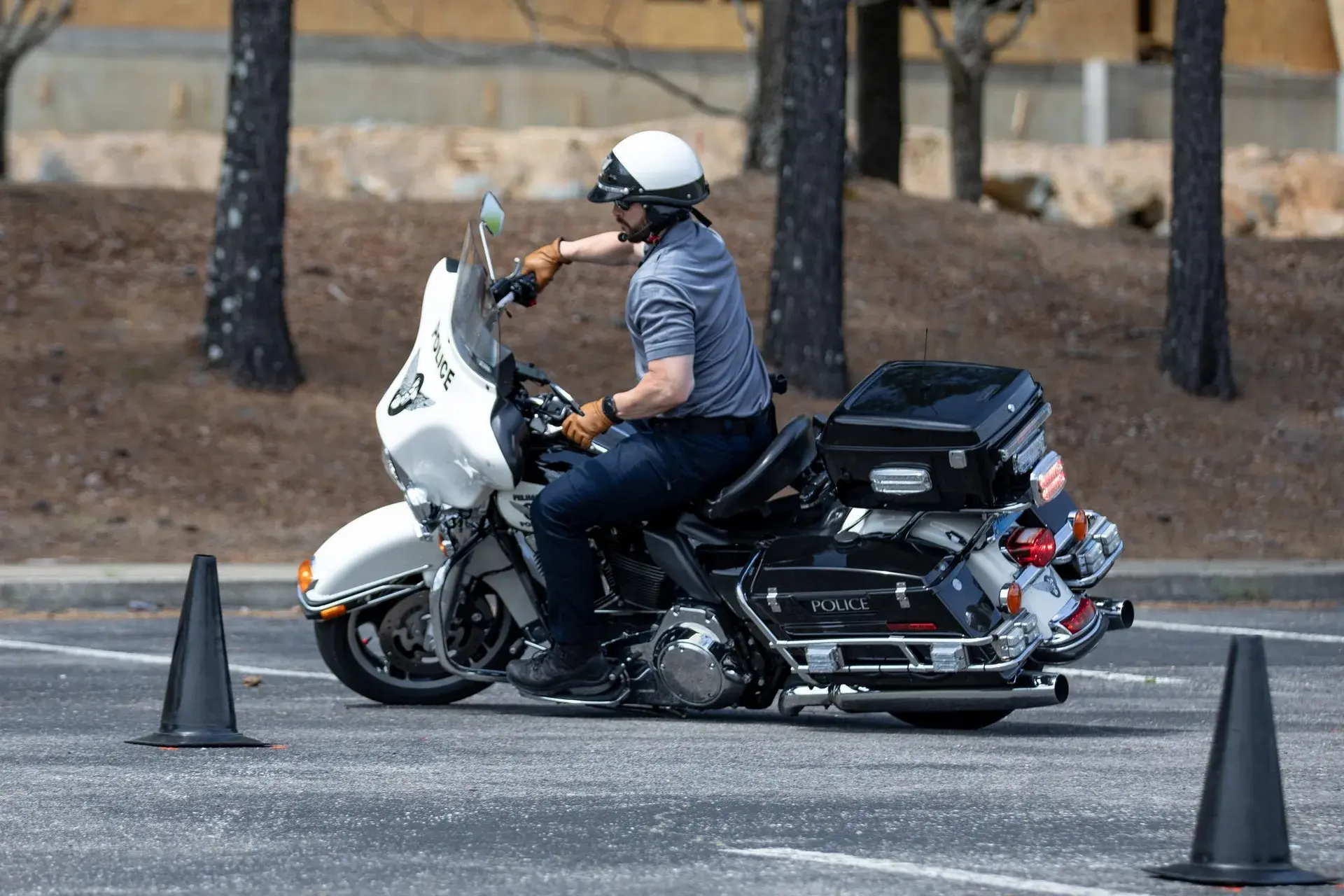 A motor officer practicing low-speed maneuvers between traffic cones