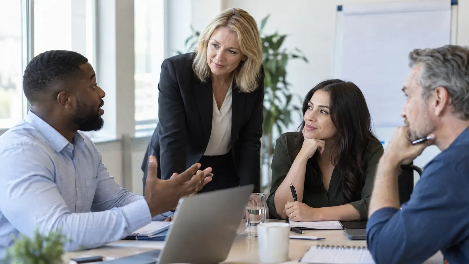 Sales professionals practice together during a small-group training workshop.