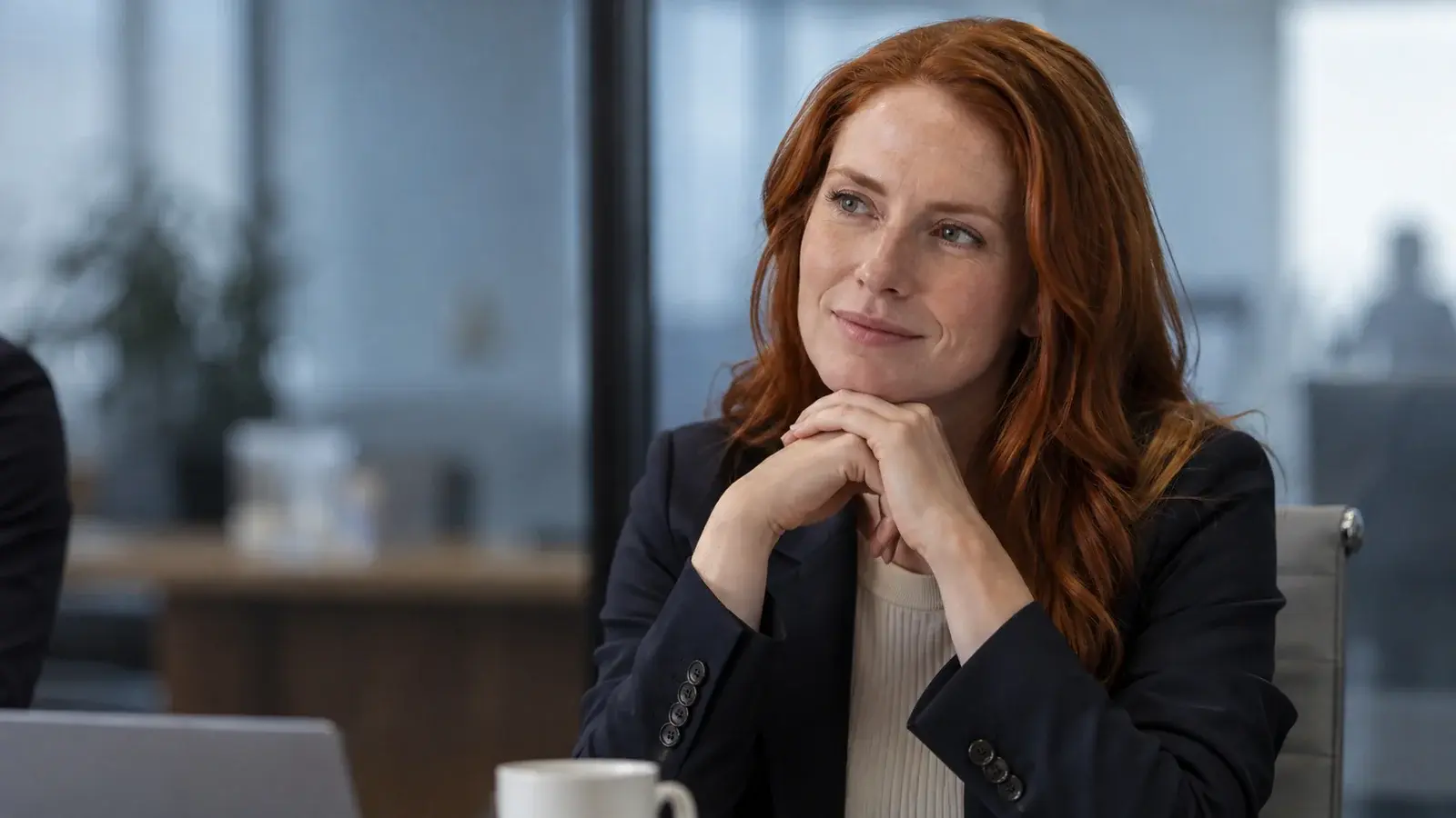 A professional reflects quietly after a business meeting.