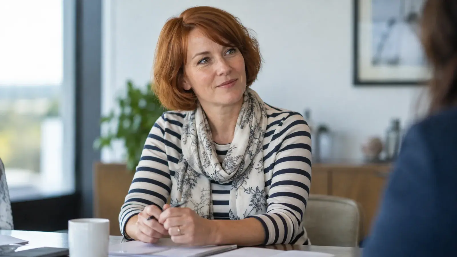A sales manager listens attentively during a coaching conversation.