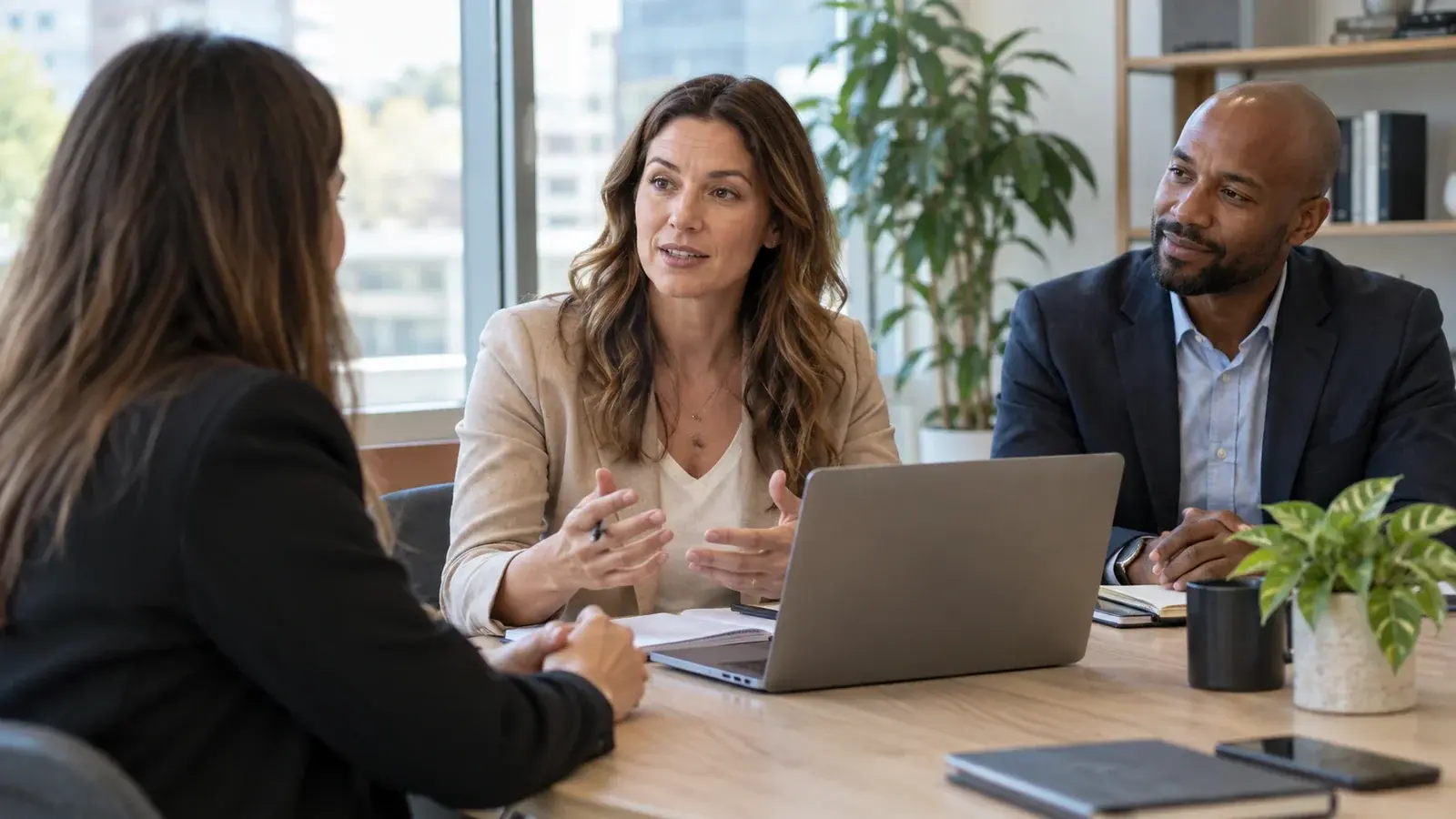 A coach observes a salesperson leading a conversation with a client.